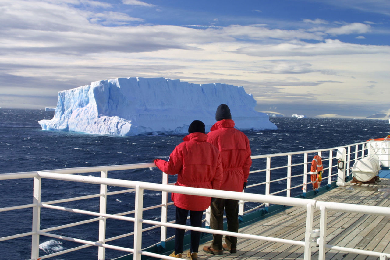 Two people looking at glacier on an Antartica Cruise